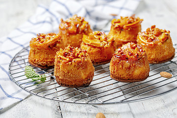 Image showing Cupcakes with caramelized orange on a metal grill.