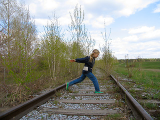 Image showing Girl  running over railway