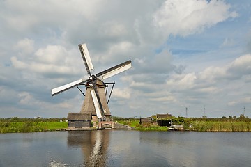 Image showing Windmill beside a canal