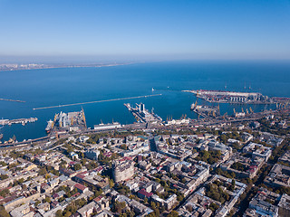 Image showing Aerial view of the drone on the city of Odessa and the sea with a maritime station against a blue sky on a sunny day