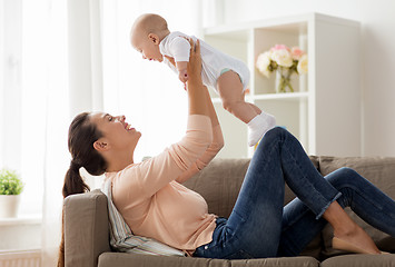 Image showing happy mother playing with little baby boy at home