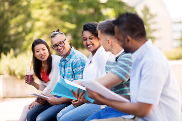 Image showing students with notebook and takeaway drinks