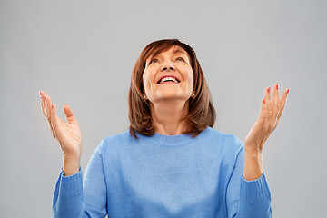 Image showing happy senior woman looking up