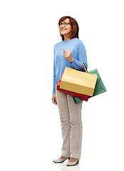 Image showing senior woman with shopping bags isolated on white