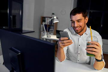 Image showing businessman with drink using smartphone at office