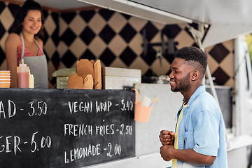 Image showing male customer looking at billboard at food truck