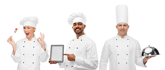 Image showing chefs with tablet computer, cloche and tomato