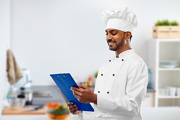 Image showing indian chef reading menu on clipboard at kitchen