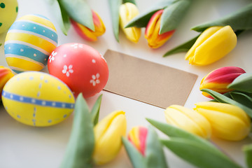 Image showing close up of colored easter eggs and tulip flowers