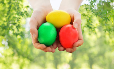 Image showing close up of girl with bowl of colored easter eggs