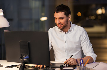 Image showing designer with computer and pen tablet at office