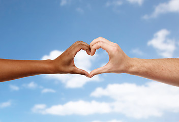 Image showing hands of different skin color making heart shape