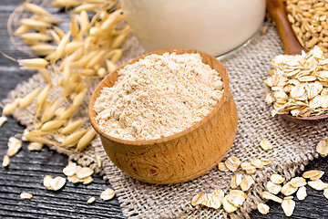 Image showing Flour oat in bowl on dark board