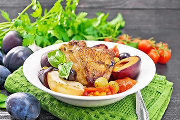 Image showing Chicken with fruits and tomatoes in plate on board