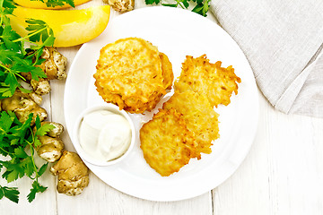 Image showing Pancakes of pumpkin with Jerusalem artichoke on white board top