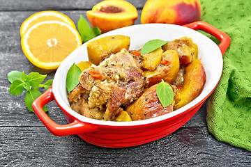 Image showing Turkey with peaches in pan on black board