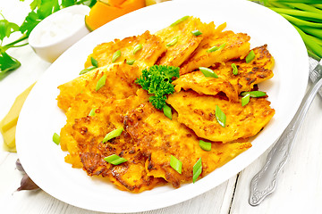 Image showing Pancakes of pumpkin with cheese in plate on white board