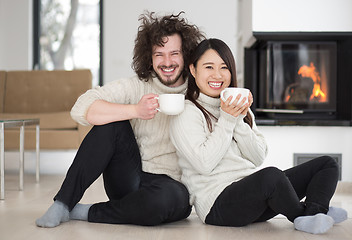 Image showing happy multiethnic couple  in front of fireplace