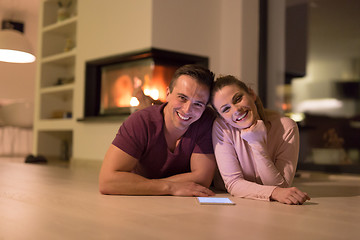 Image showing Young Couple using digital tablet on cold winter night