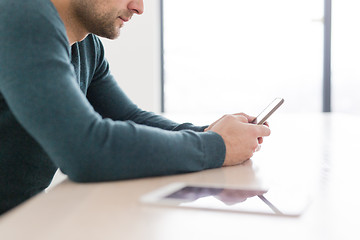 Image showing Young casual businessman using smartphone