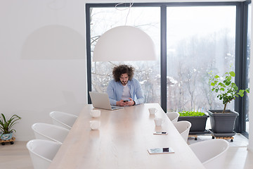 Image showing Young casual businessman using smartphone