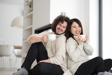 Image showing happy multiethnic couple  in front of fireplace