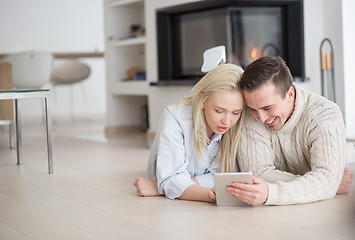 Image showing Young Couple using digital tablet on cold winter day