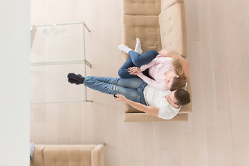 Image showing Young couple on the sofa watching television top view