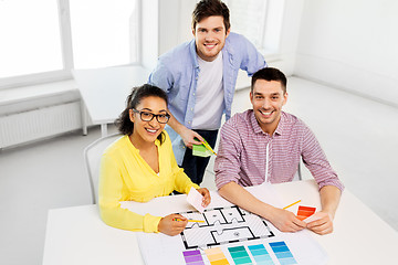 Image showing designers with blueprint and color samples