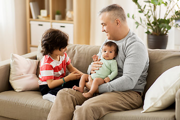 Image showing happy father with preteen and baby son at home