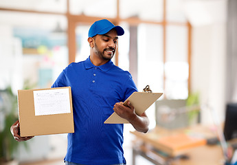 Image showing delivery man with parcel and clipboard at office