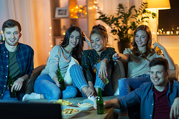 Image showing friends with drinks and snacks watching tv at home