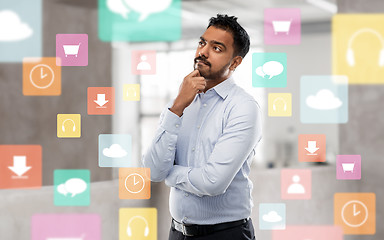 Image showing indian businessman thinking with app icons