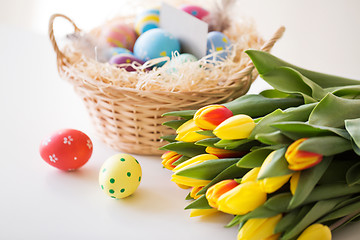 Image showing close up of colored easter eggs and tulip flowers