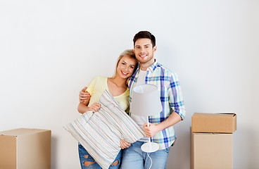 Image showing couple with pillow and lamp moving to new home