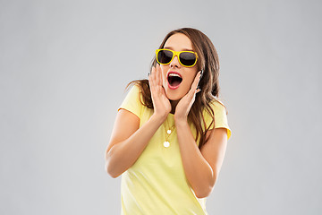 Image showing amazed teenage girl in yellow sunglasses