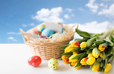 Image showing close up of colored easter eggs and tulip flowers