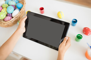 Image showing child hands with tablet pc, easter eggs and colors