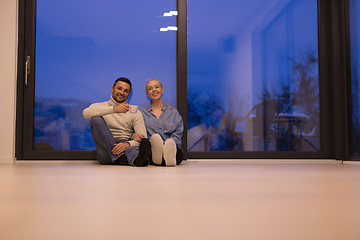 Image showing happy couple in front of fireplace