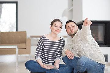 Image showing Young Couple using digital tablet on cold winter day