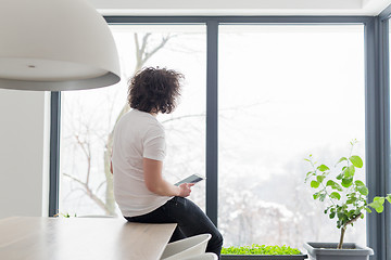 Image showing young man using a tablet at home