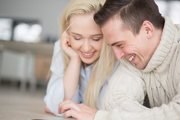 Image showing Young Couple using digital tablet on cold winter day