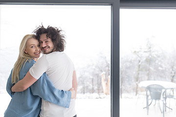 Image showing young couple enjoying morning coffee by the window