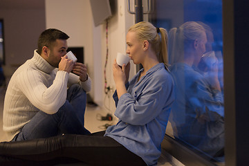 Image showing happy couple in front of fireplace