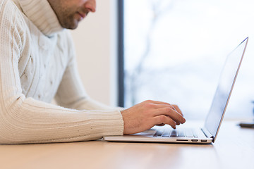 Image showing businessman working using a laptop in startup office