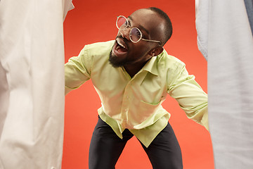 Image showing Handsome man with beard choosing shirt in a shop