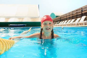 Image showing The portrait of happy smiling beautiful teen girl at the pool