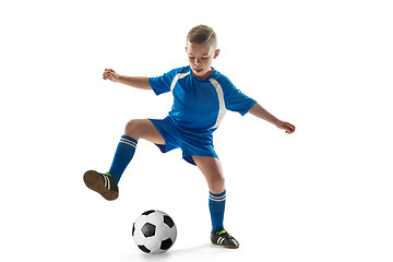 Image showing Young boy with soccer ball doing flying kick