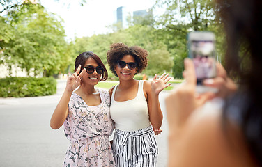 Image showing woman photographing her friends in summer park