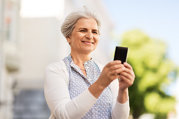 Image showing happy senior woman with smartphone in summer